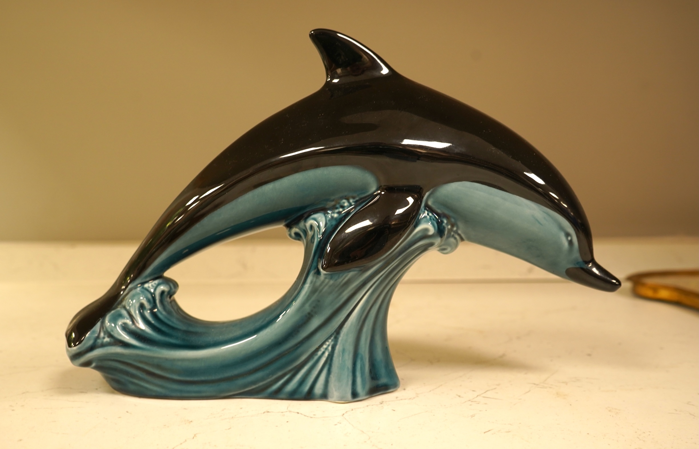 A Poole Pottery hors d’ouevres dish, a dolphin, a box and cover and a Torquay ware Brixham jar